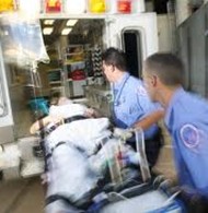Women being taken away by ambulance